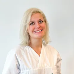 En kvinne som smiler til kameraet